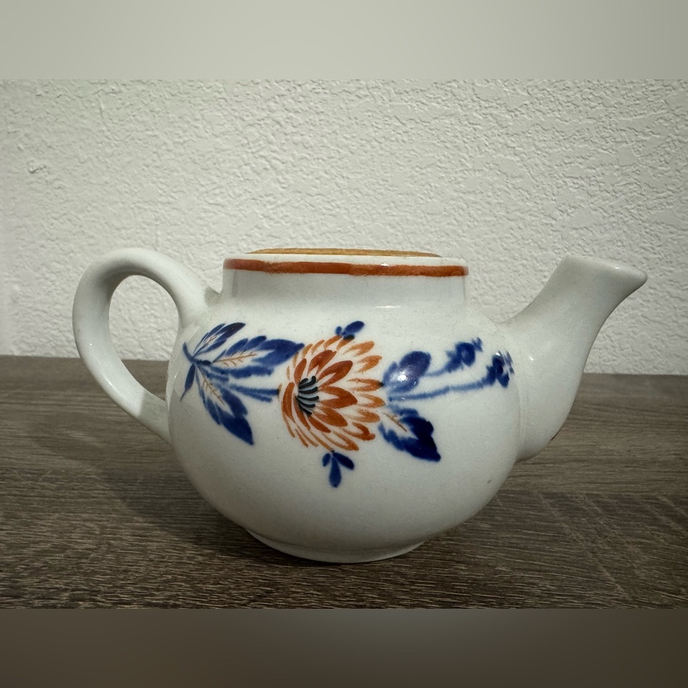 Vintage Floral Ceramic Teapot with Blue and Orange Design